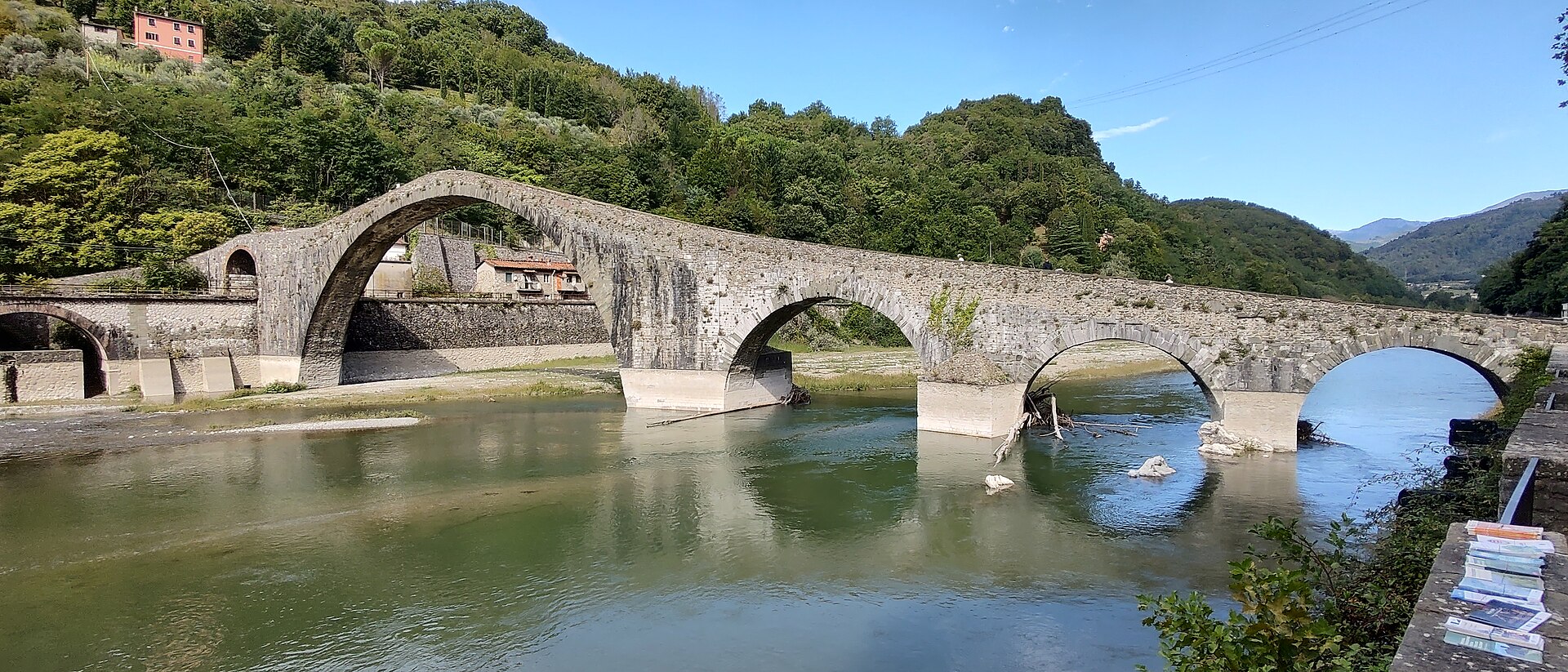 The humpbacked Ponte della Maddalena (Devil's Bridge) arching over the Serchio river at Borgo a Mozzano