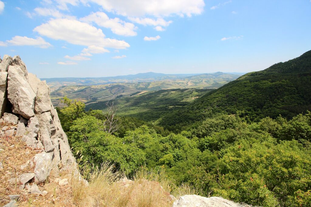 Limestone outcrop and wooded hills seen from the Rocca di Campigliola at Campiglia d'Orcia