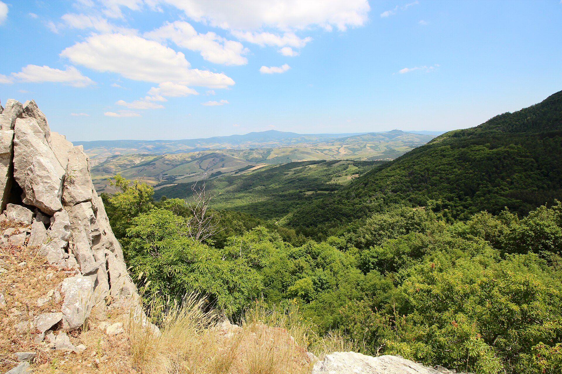 Limestone outcrop and wooded hills seen from the Rocca di Campigliola at Campiglia d'Orcia
