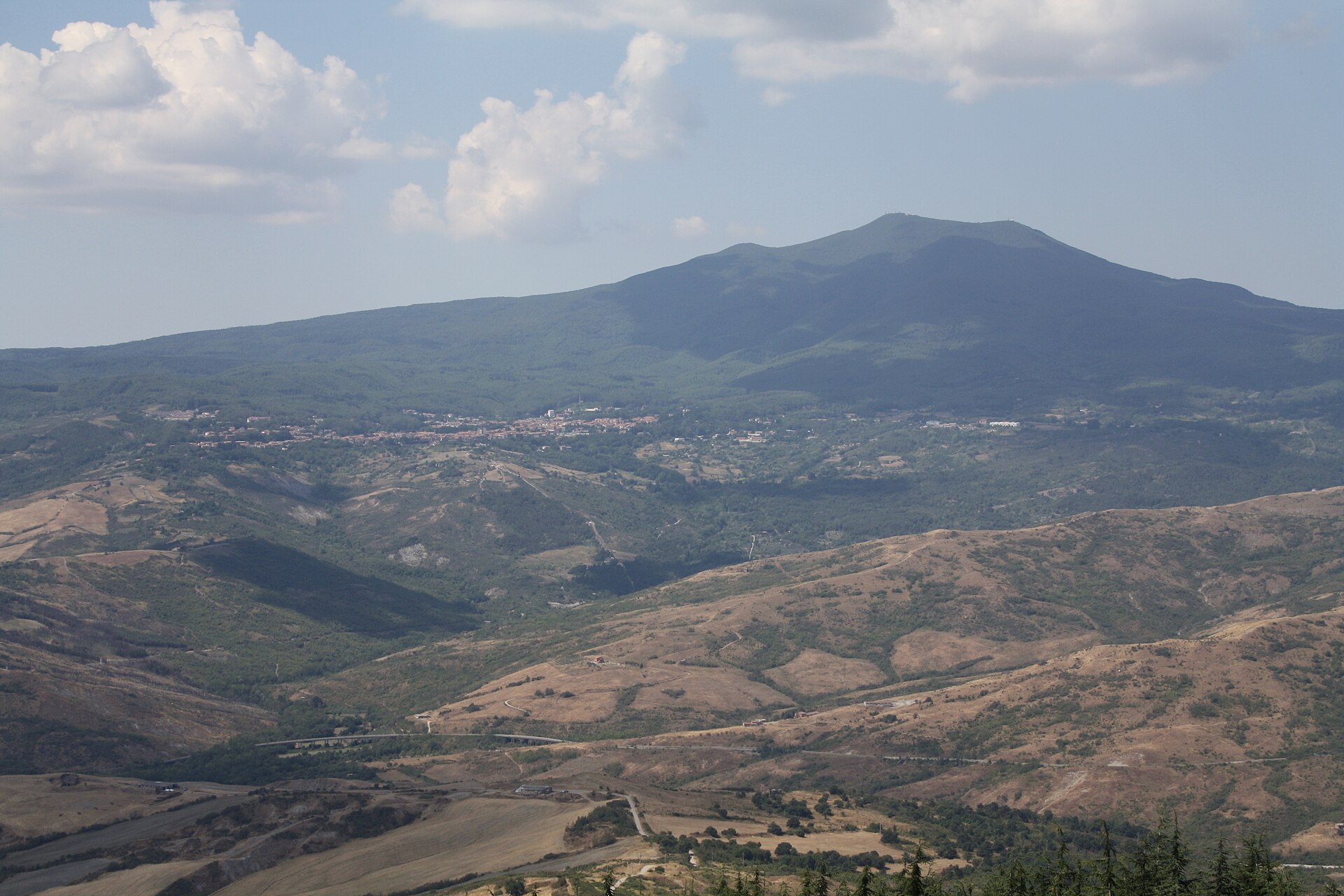 Monte Amiata seen from Radicofani across wooded hills and bare clay slopes