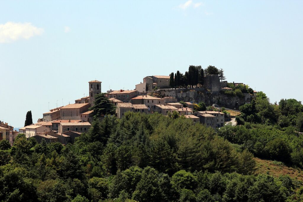 Semproniano's hilltop village and castle above green woods in southern Amiata
