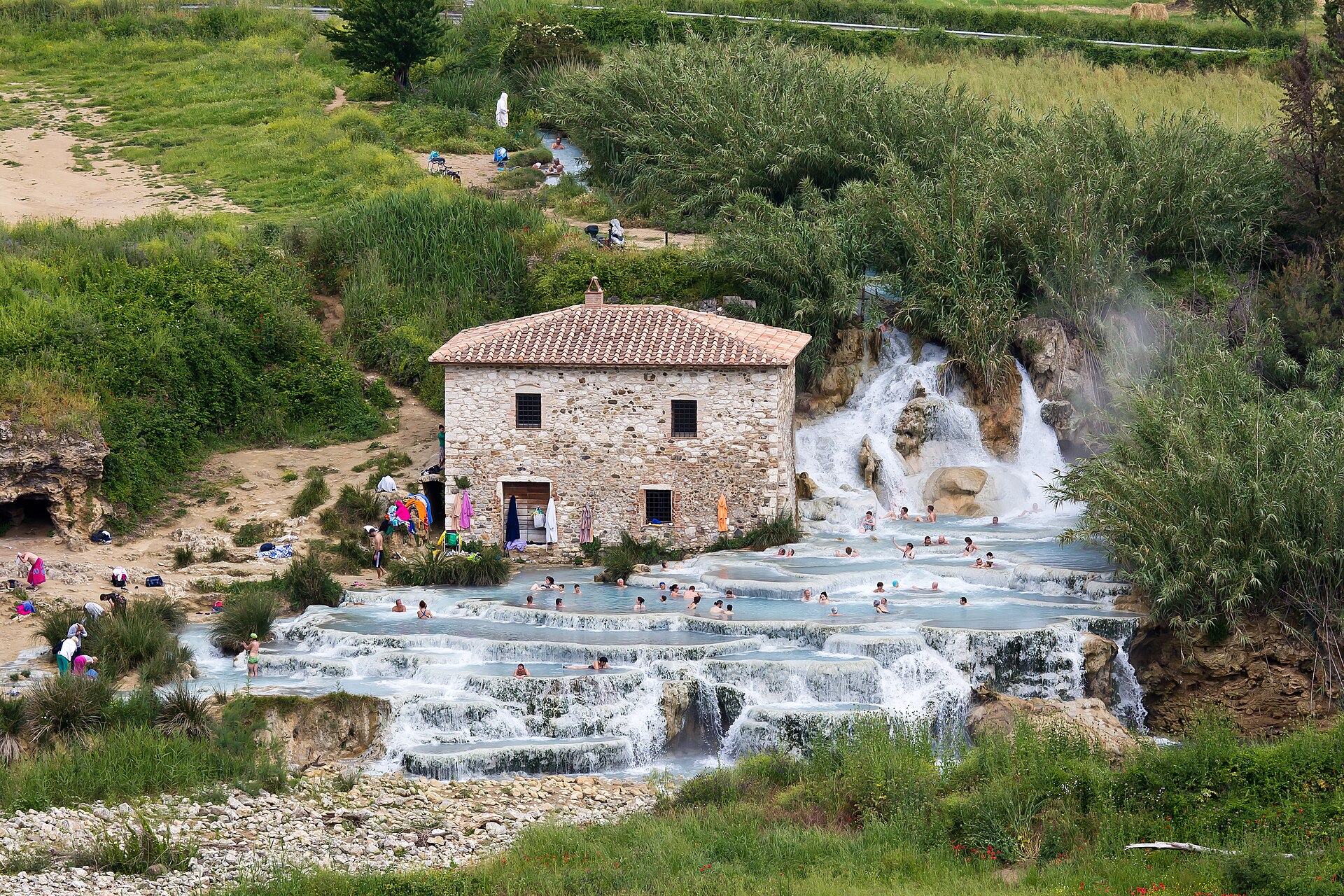 The travertine pools of the Cascate del Mulino below Saturnia, with the old mill behind
