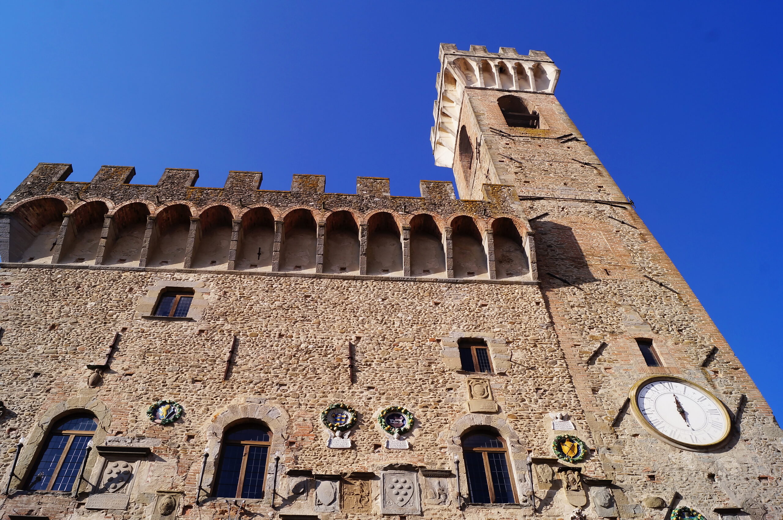 Palazzo dei Vicari in Scarperia, its facade covered in stone coats of arms