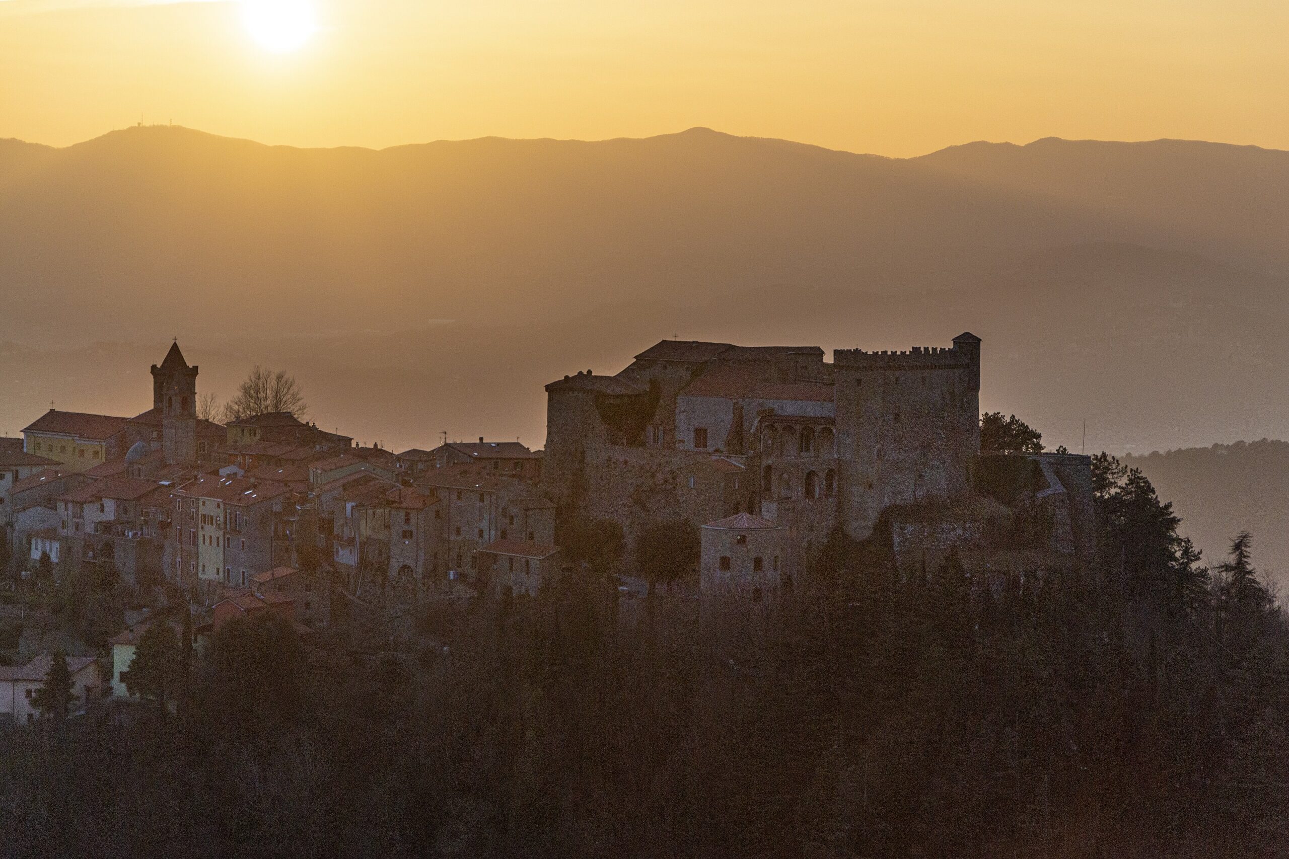 The Malaspina castle of Fosdinovo and its village at dusk