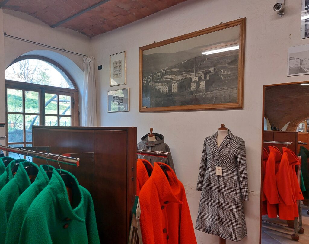 Coats and garments in orange and green Panno Casentino cloth at Tessilnova in Stia