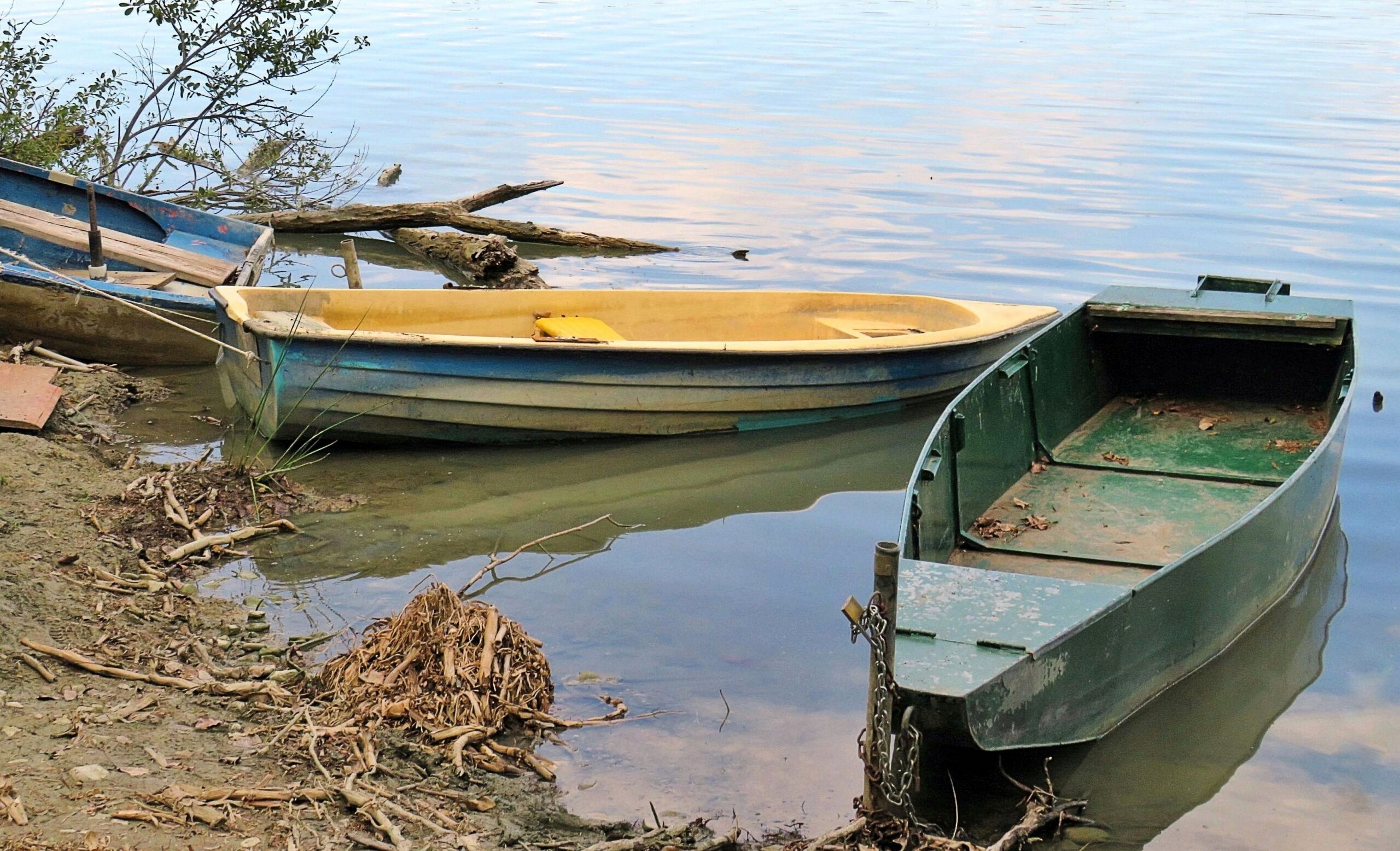 Wooden boats moored on the shore of Lake Chiusi