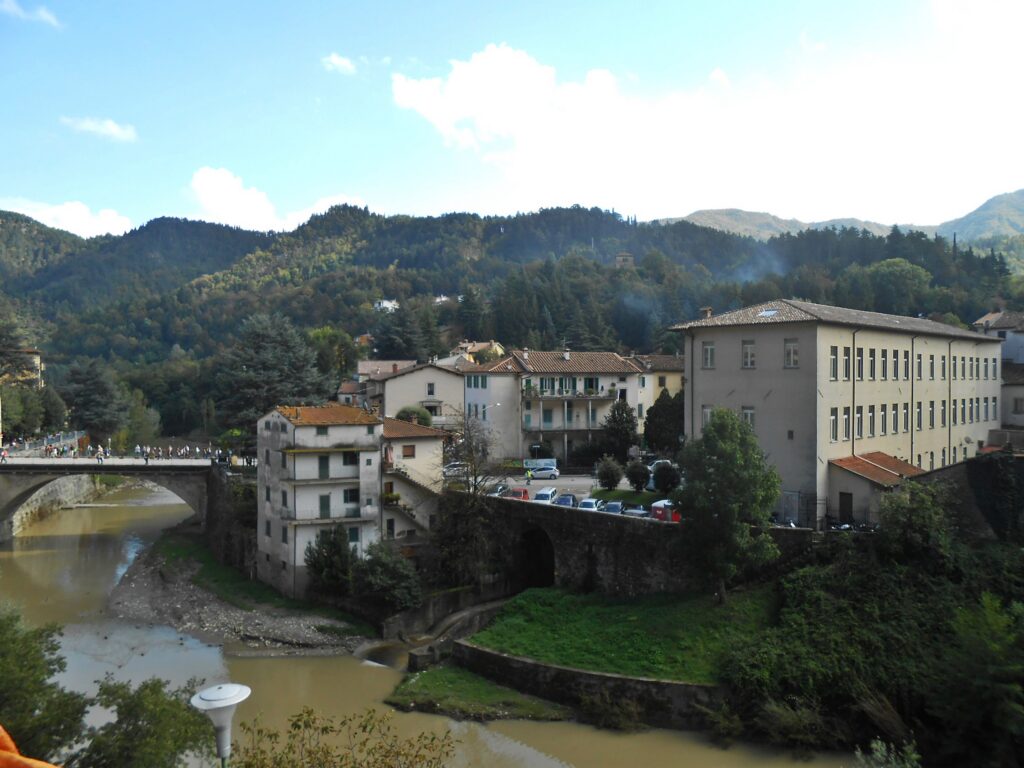 Marradi on the Lamone river, with its stone bridge and wooded Apennine hills behind