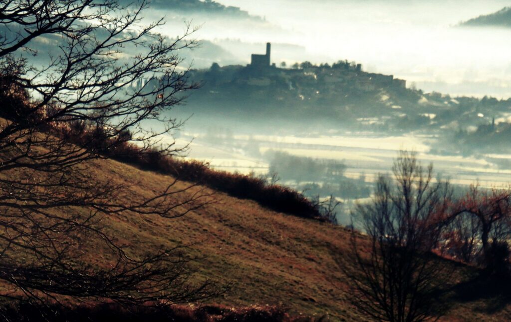 Poppi castle rising above morning mist in the Casentino valley