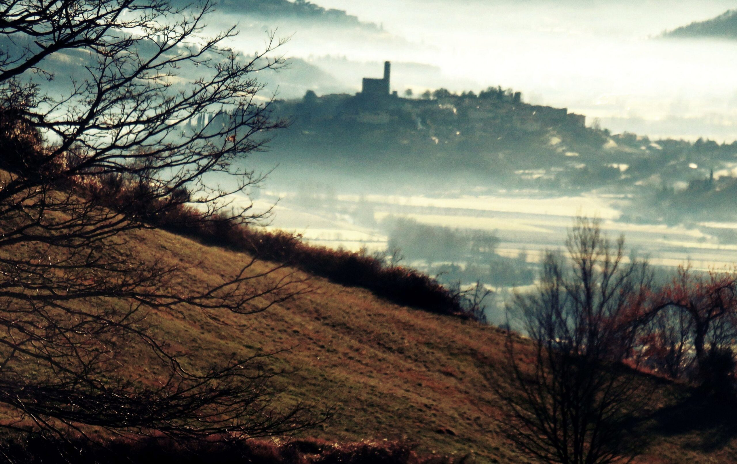 Poppi castle rising above morning mist in the Casentino valley