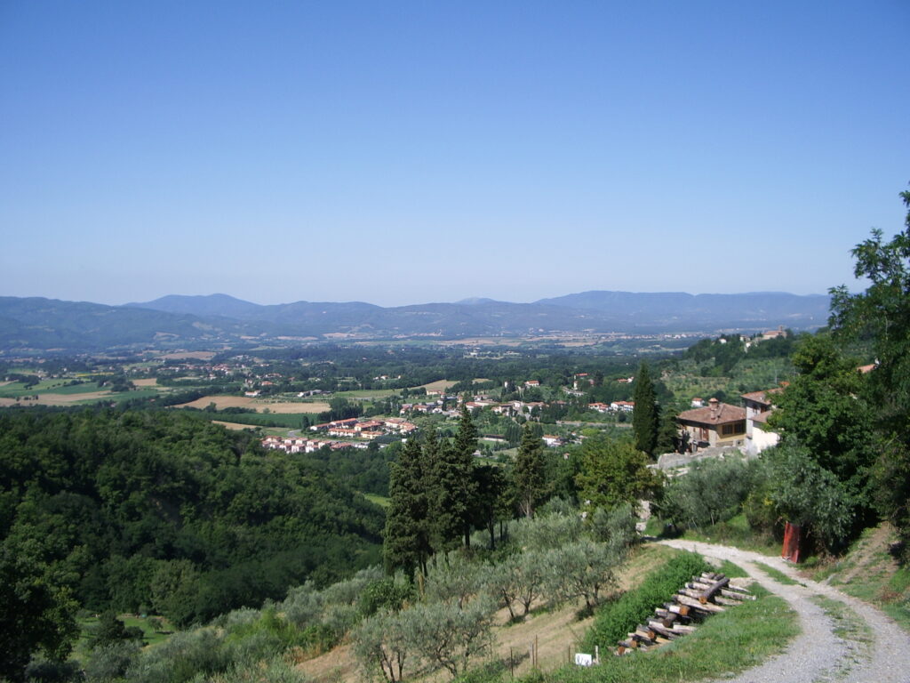 The Mugello valley seen from the hills above Ronta, green fields and Apennine ridges in the distance